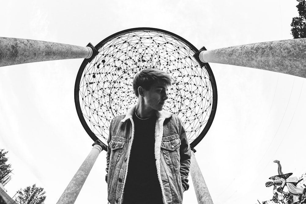 a man is standing in front of a sculpture