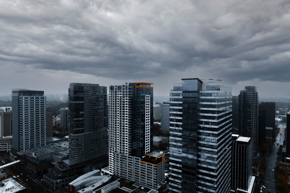 a city with tall buildings under a cloudy sky