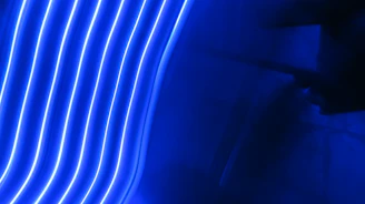 A vibrant mockup of a deep navy and electric blue business website glowing with subtle neon pulse lines.