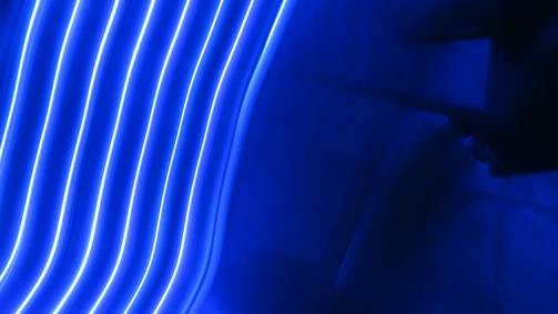 A vibrant mockup of a deep navy and electric blue business website glowing with subtle neon pulse lines.