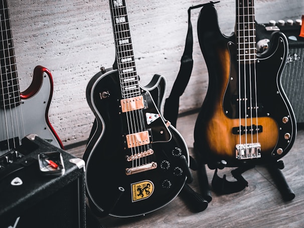 a group of guitars sitting on top of a wooden floor