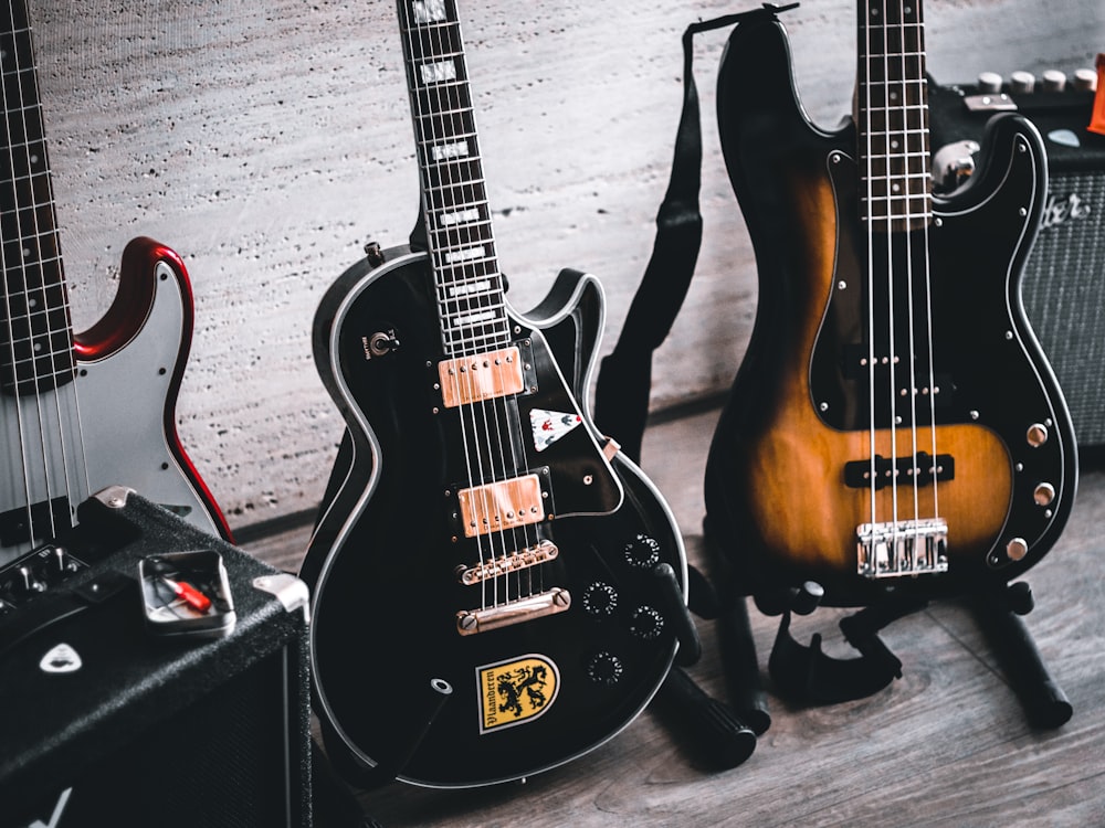 a group of guitars sitting on top of a wooden floor