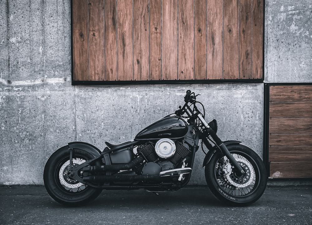 a black motorcycle parked in front of a building