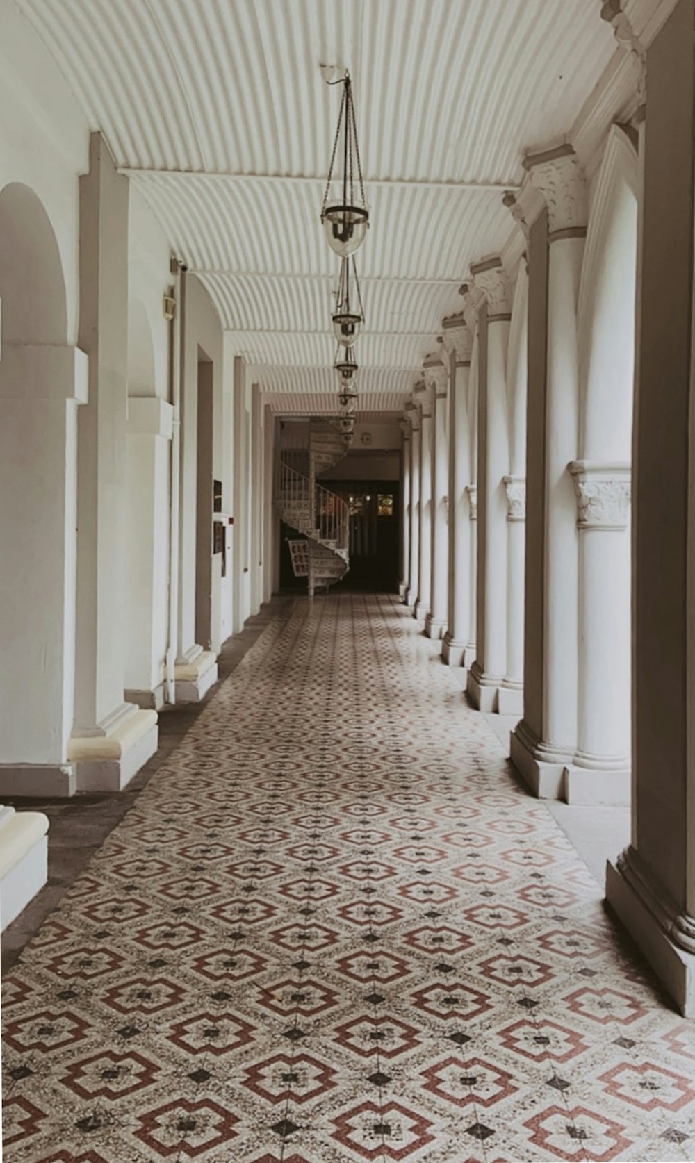 a long hallway with a chandelier hanging from the ceiling