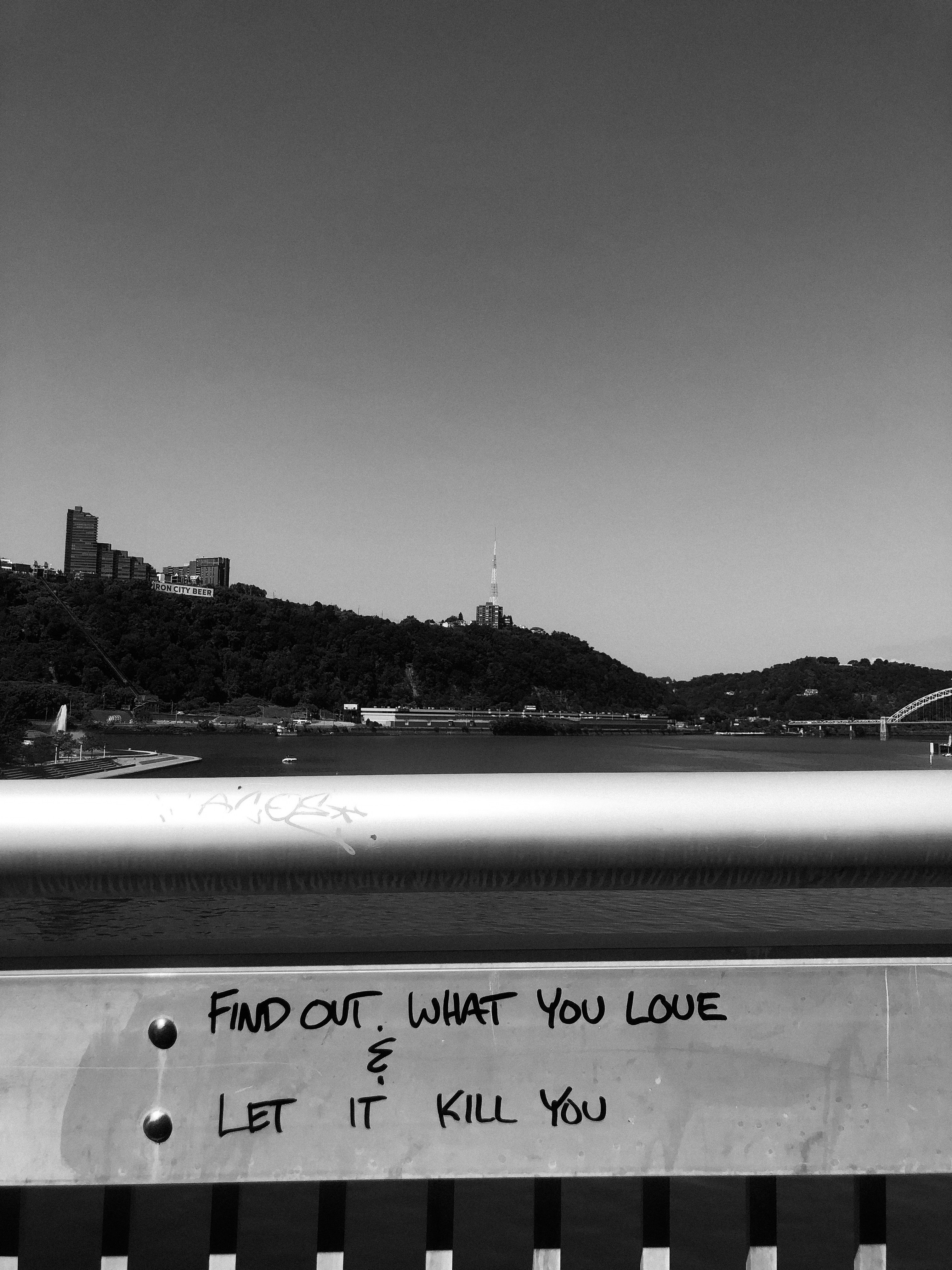 a black and white photo of a bridge with graffiti on it