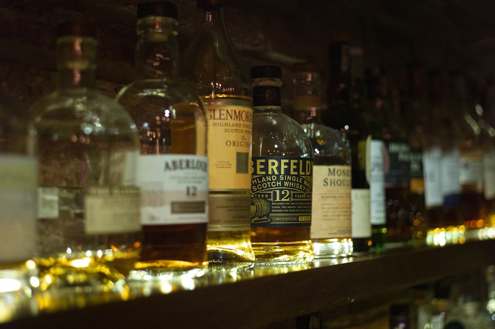 a row of bottles of alcohol on a shelf