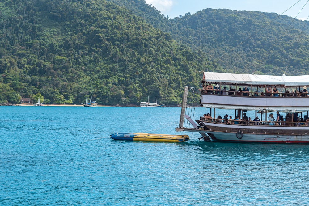 a large boat with people on it in the water