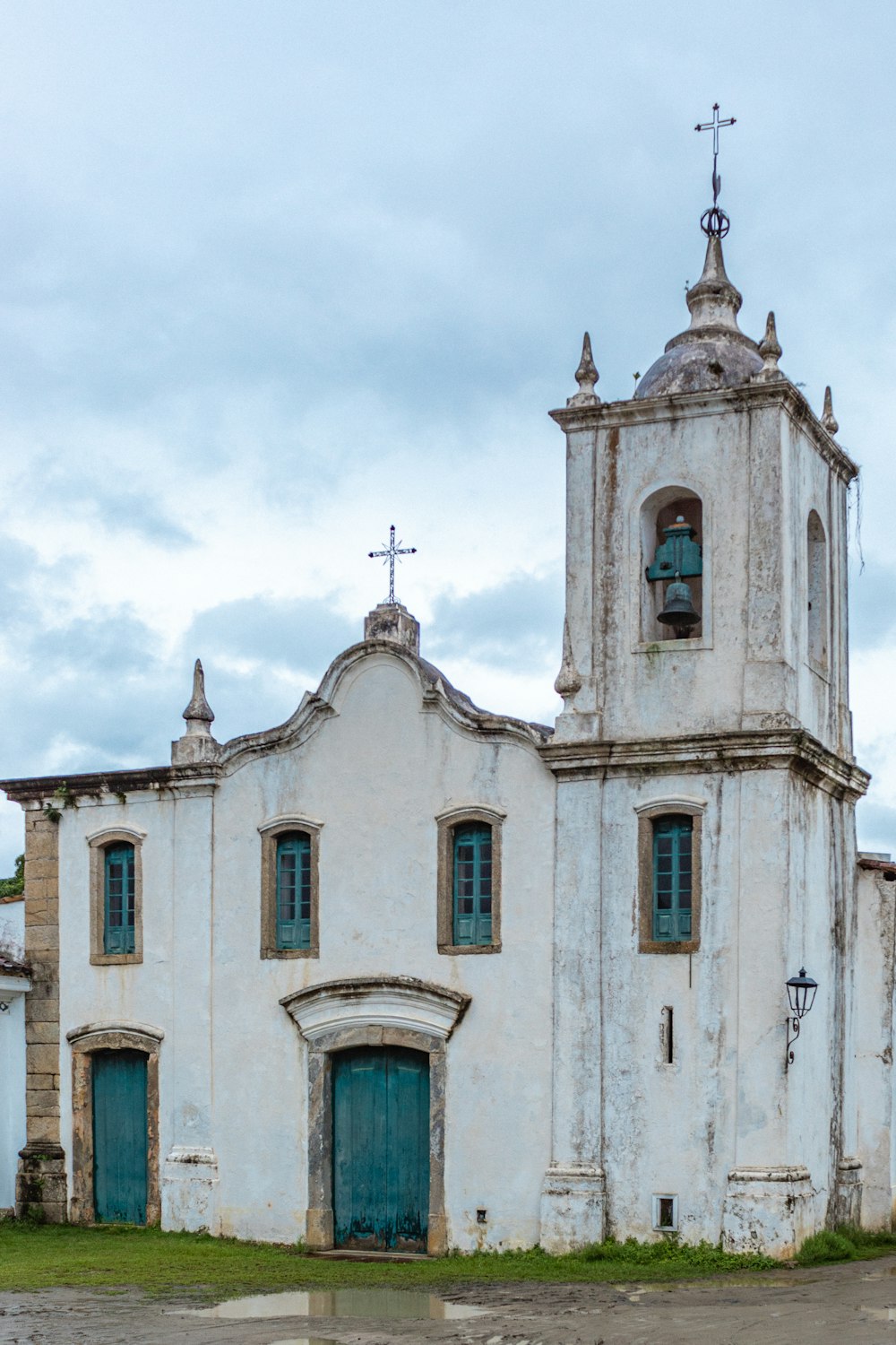 an old white church with a blue door