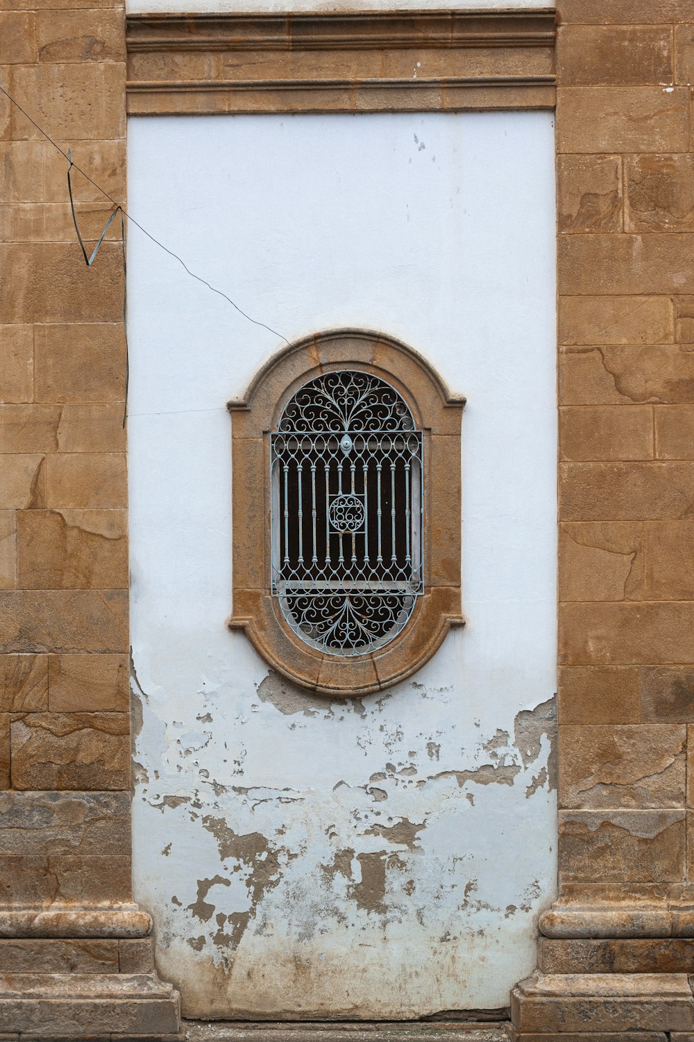 a window with a bird cage on the side of a building