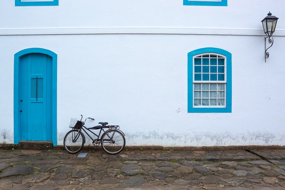a bike parked in front of a white building