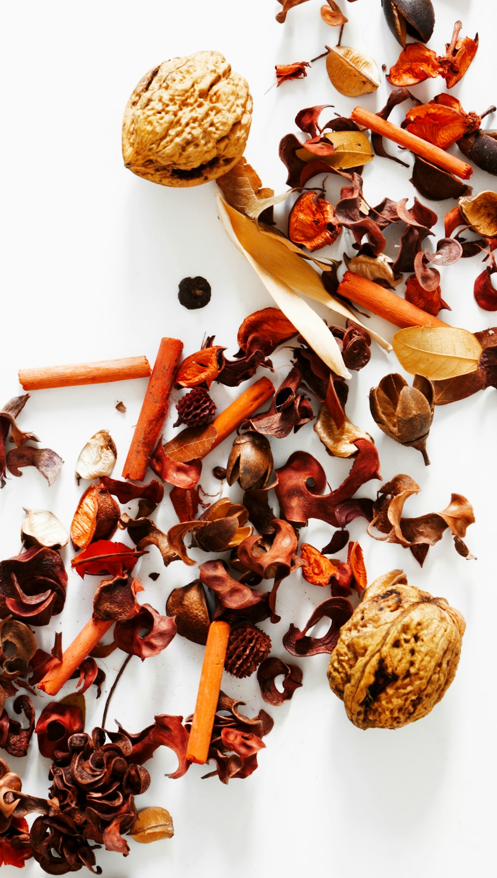 a pile of dried fruits and vegetables on a white surface