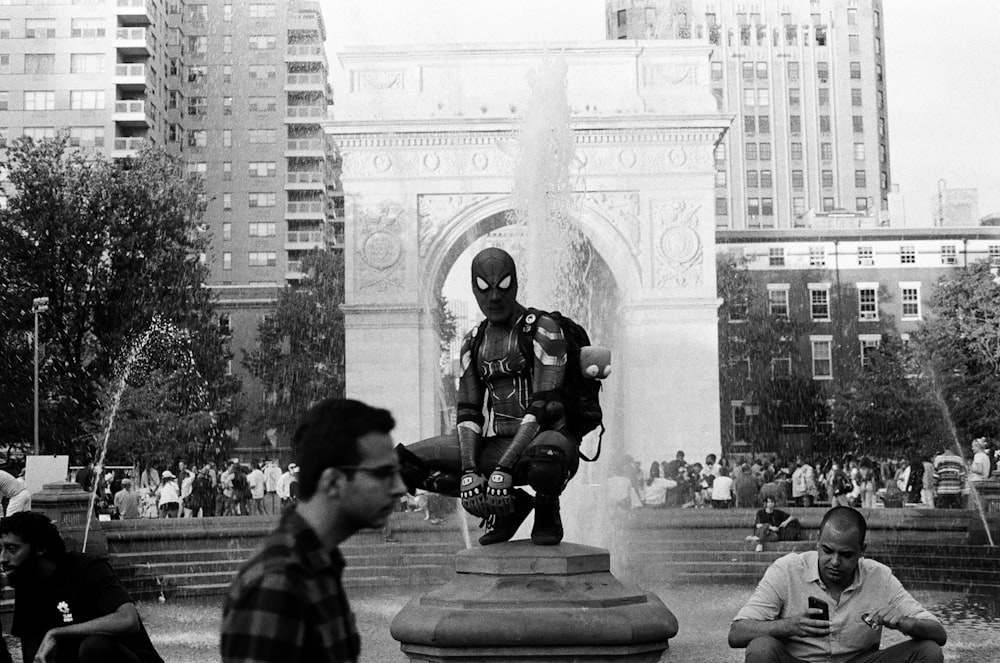 a group of people sitting around a fountain