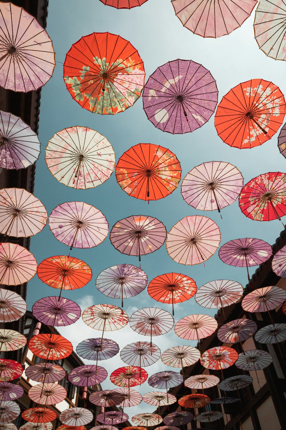 a bunch of umbrellas that are hanging in the air