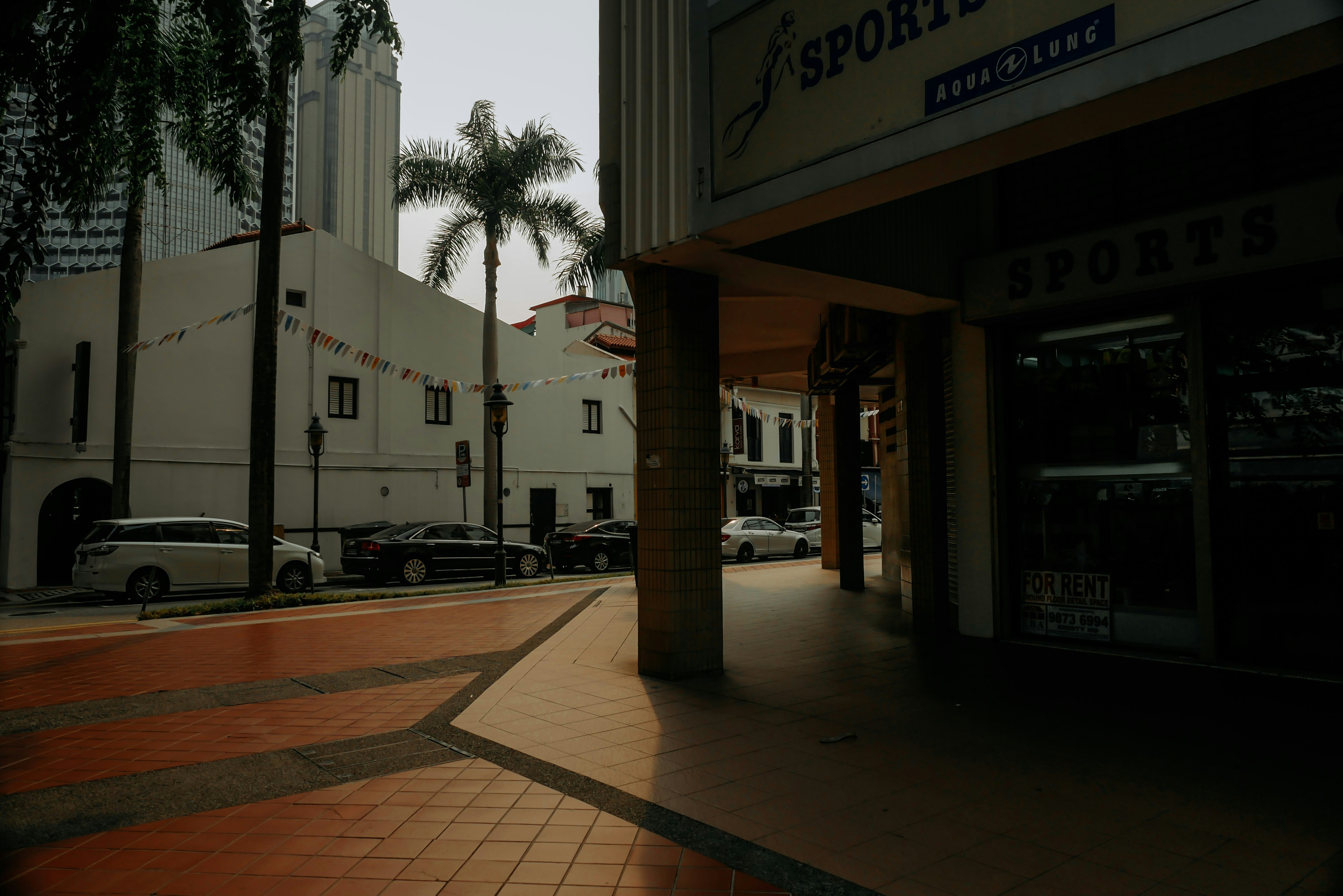 a city street with cars parked on the side of it