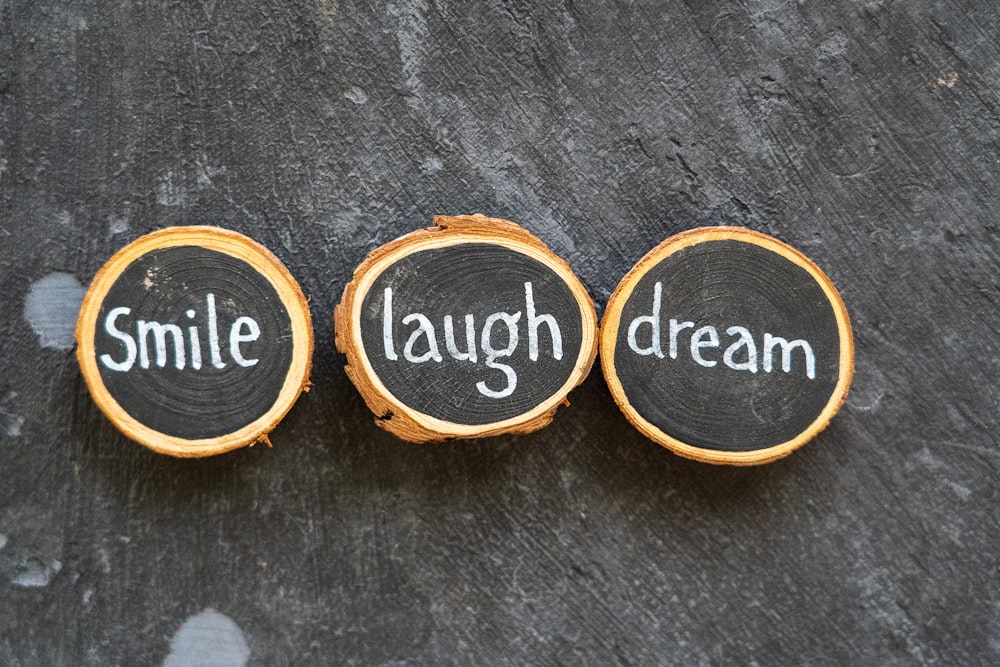 three slices of wood with words written on them