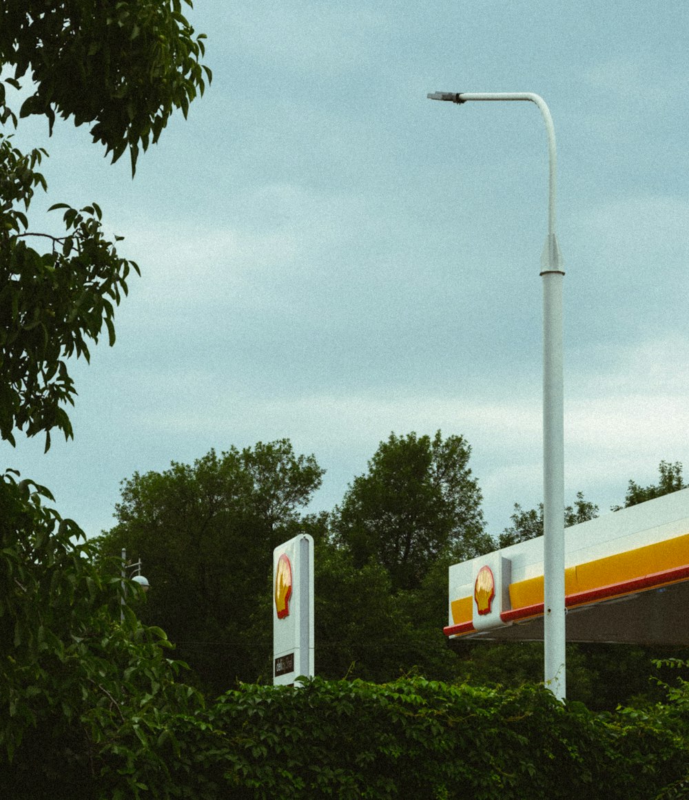 a gas station with a gas station sign in the foreground