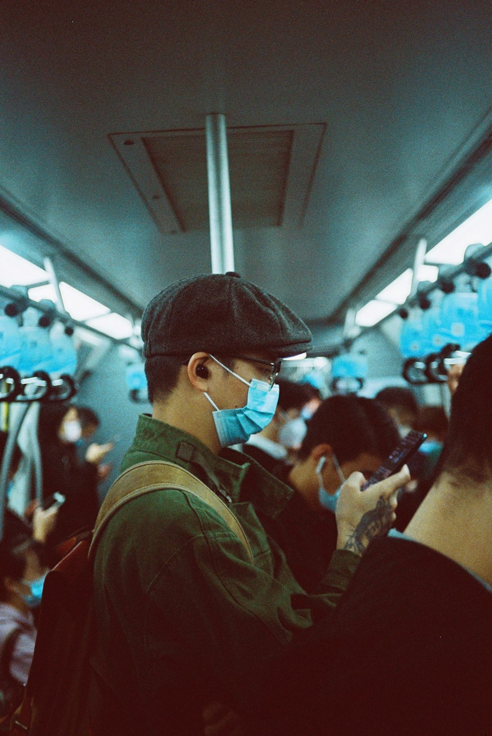 a man wearing a face mask on a train