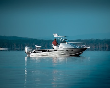 a man is riding a boat in the water