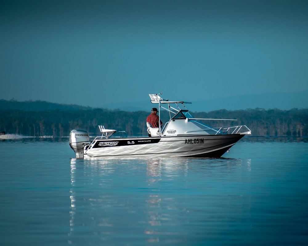 a man is riding a boat in the water