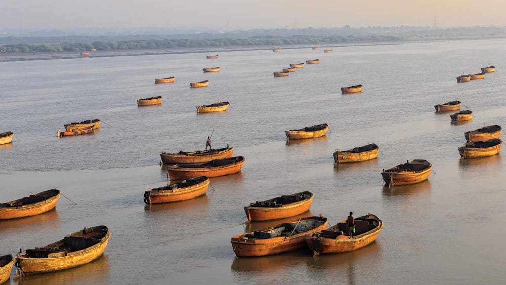 a large group of boats floating on top of a lake