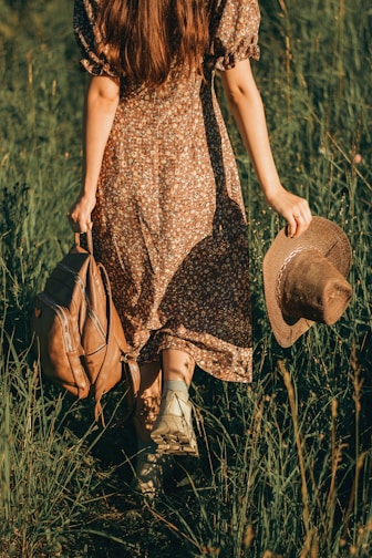 a person that is standing in the grass