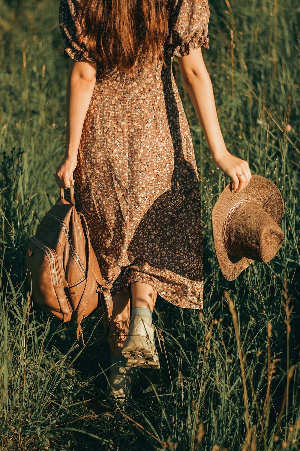 a person that is standing in the grass