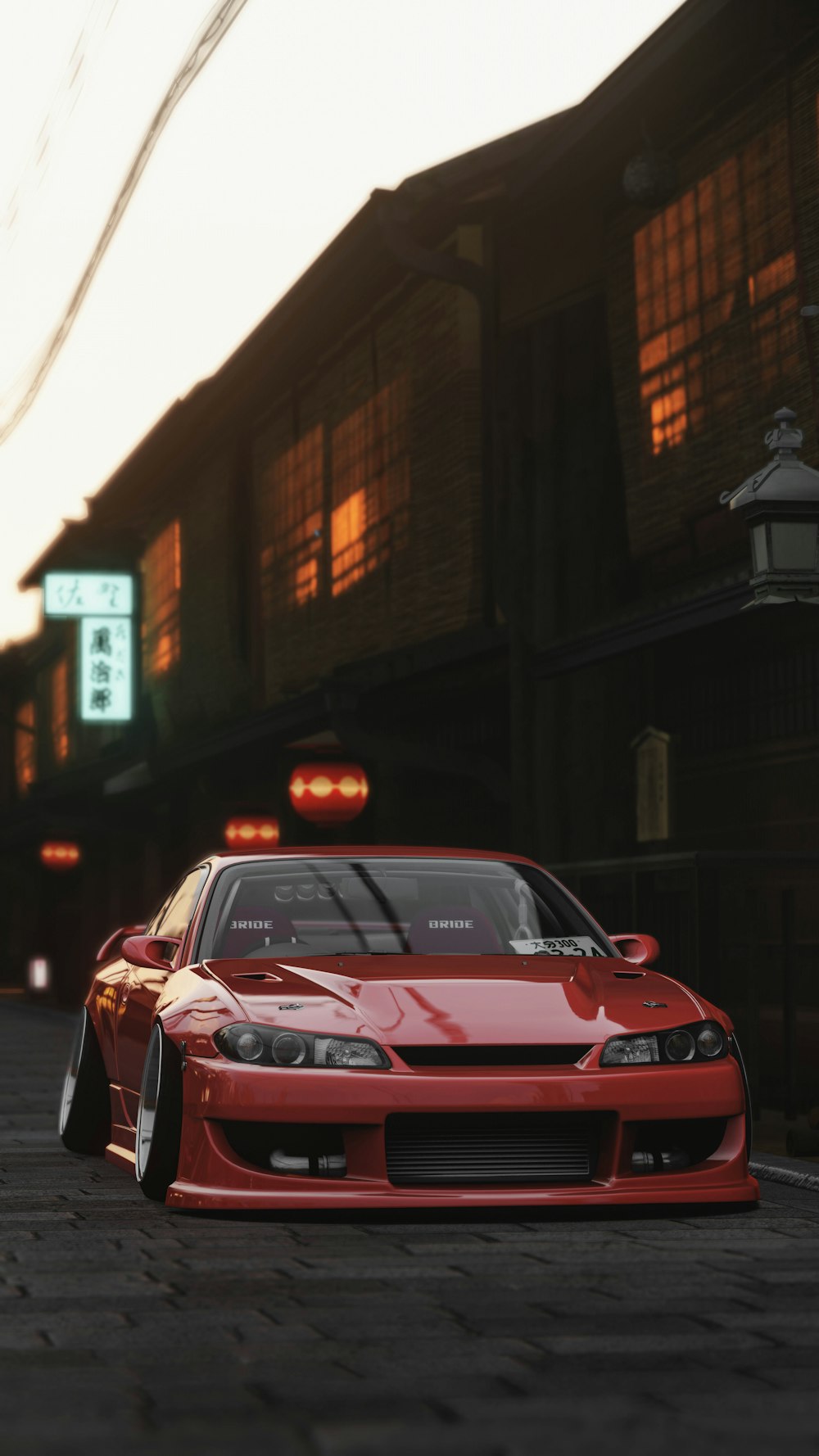 a red car parked in front of a tall building