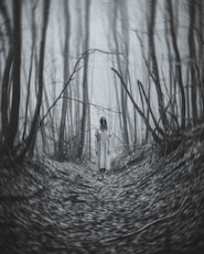 a woman standing in the middle of a forest