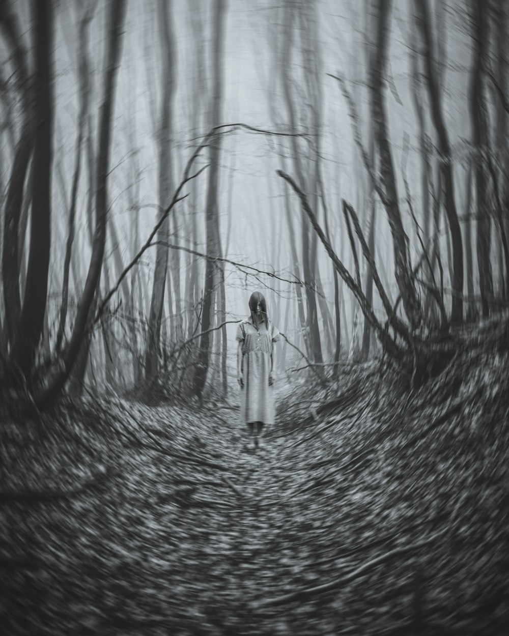 a woman standing in the middle of a forest