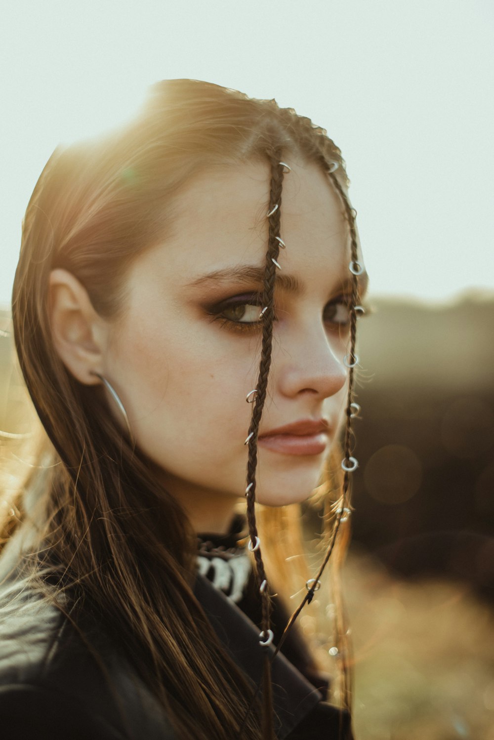 a woman with long hair wearing a chain around her neck