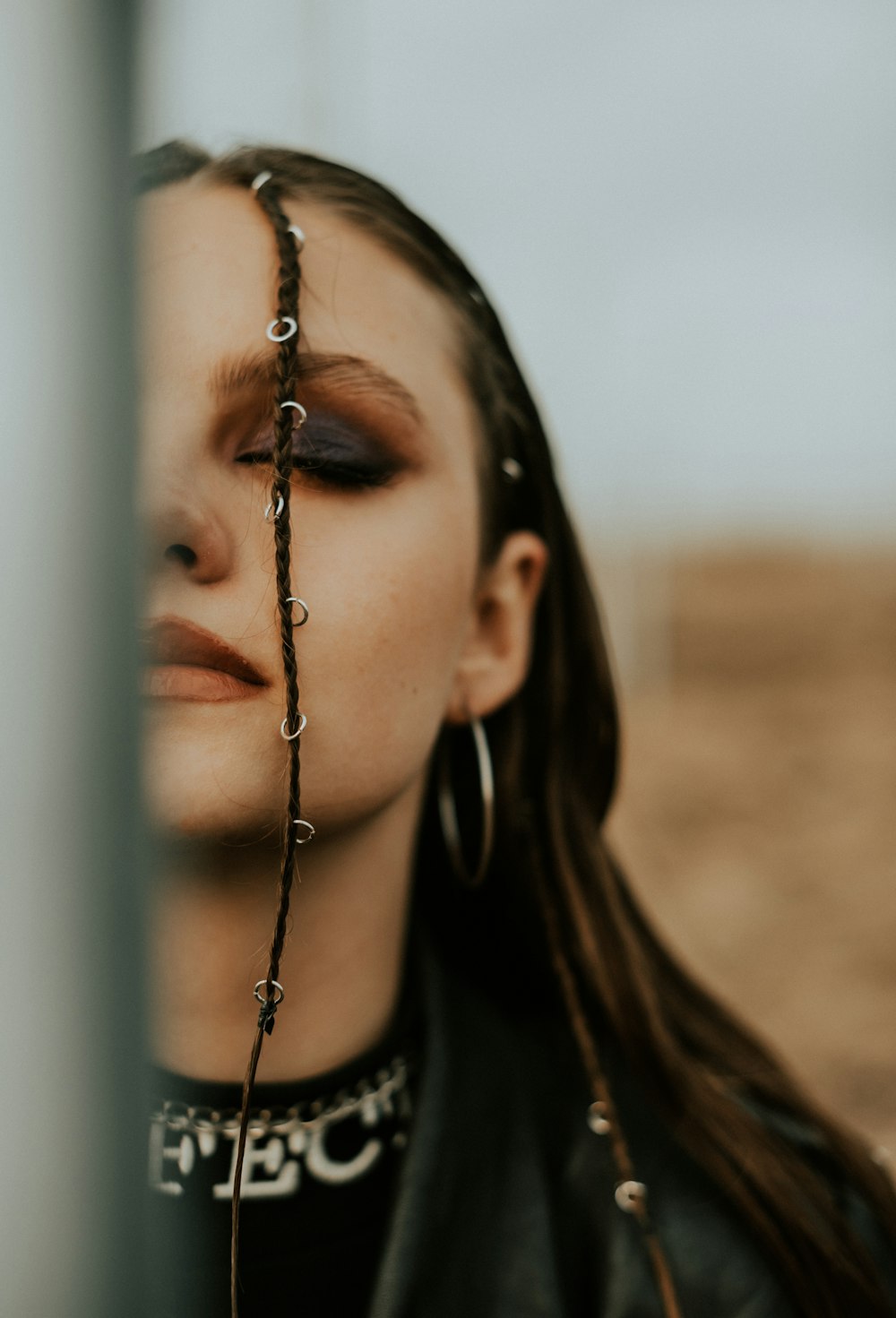 a woman with long hair wearing a leather jacket