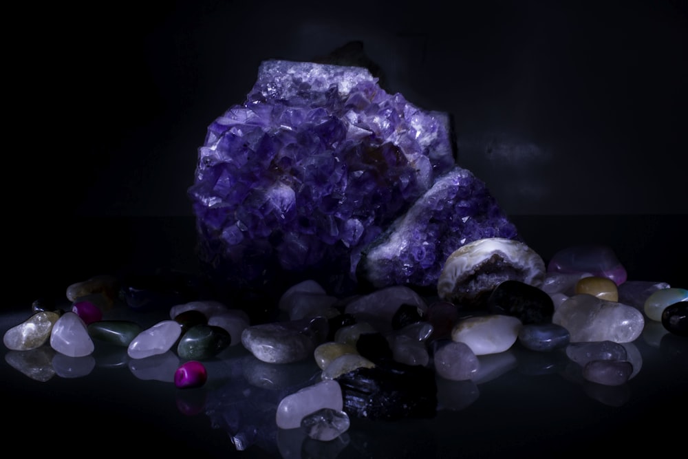 a cluster of rocks and crystals on a black surface