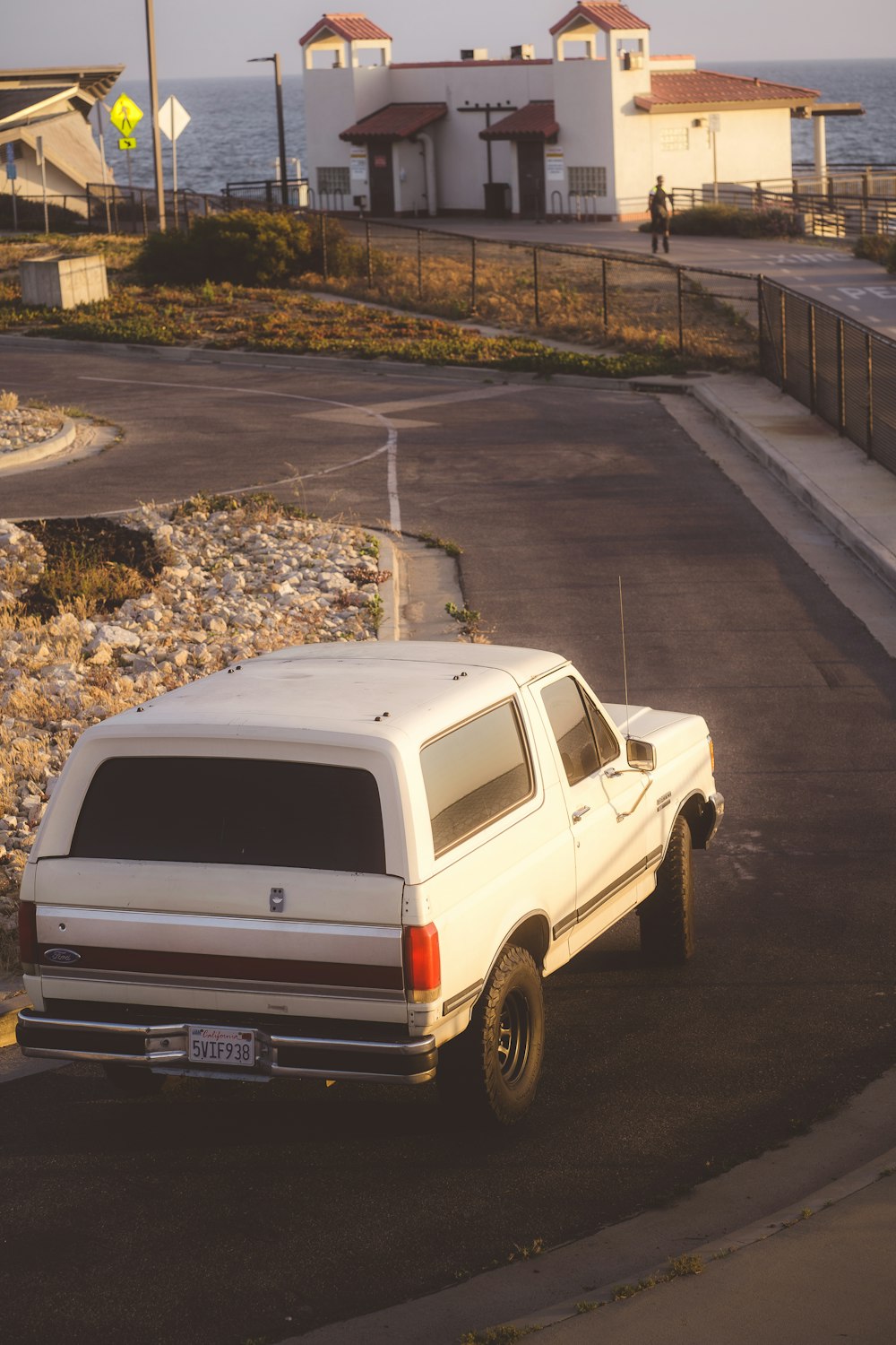 a white pick up truck parked on the side of the road
