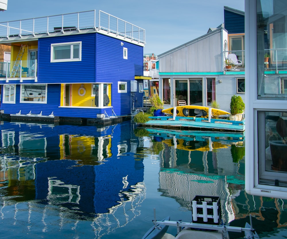 a blue house sitting on top of a body of water