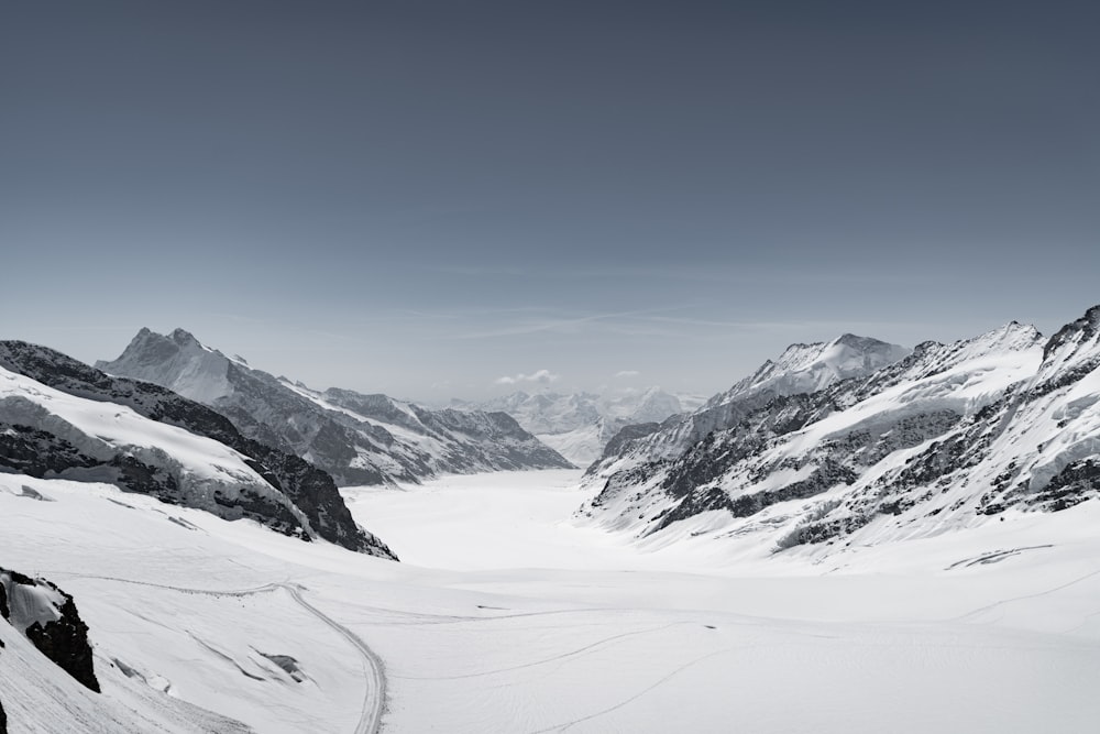 a black and white photo of a snow covered mountain