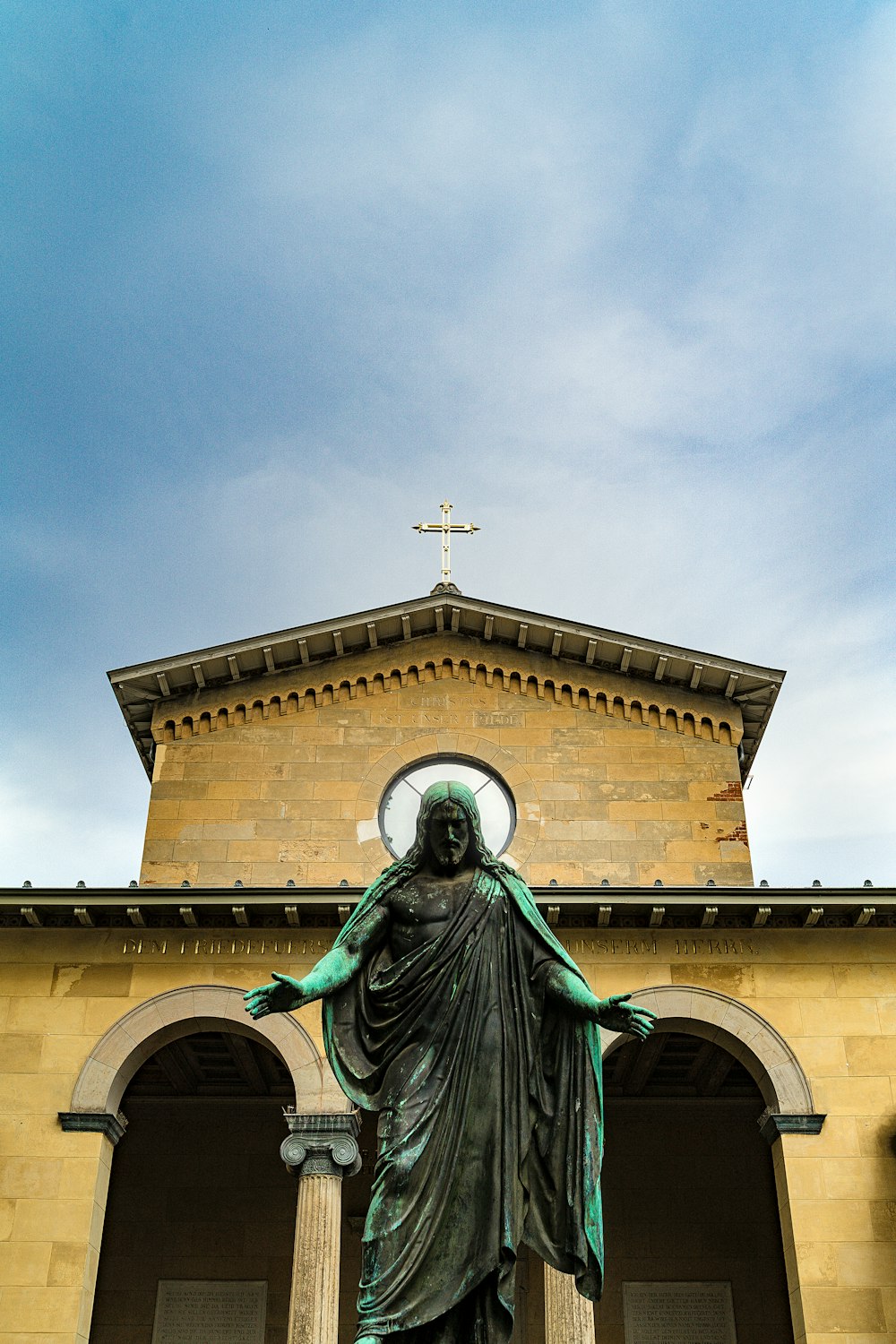 a statue of a woman in front of a church