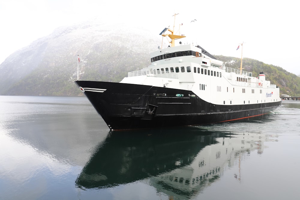 a large white and black boat in a body of water