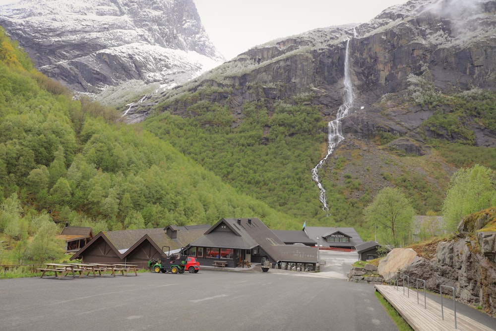 a mountain side resort with a waterfall in the background