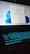 A laptop with a glowing backlit keyboard and a desktop screen displaying various icons and applications. The keyboard emits a blue-green light, creating a futuristic look. The desktop screen shows a start menu with pinned and recommended applications, set against a light blue background.