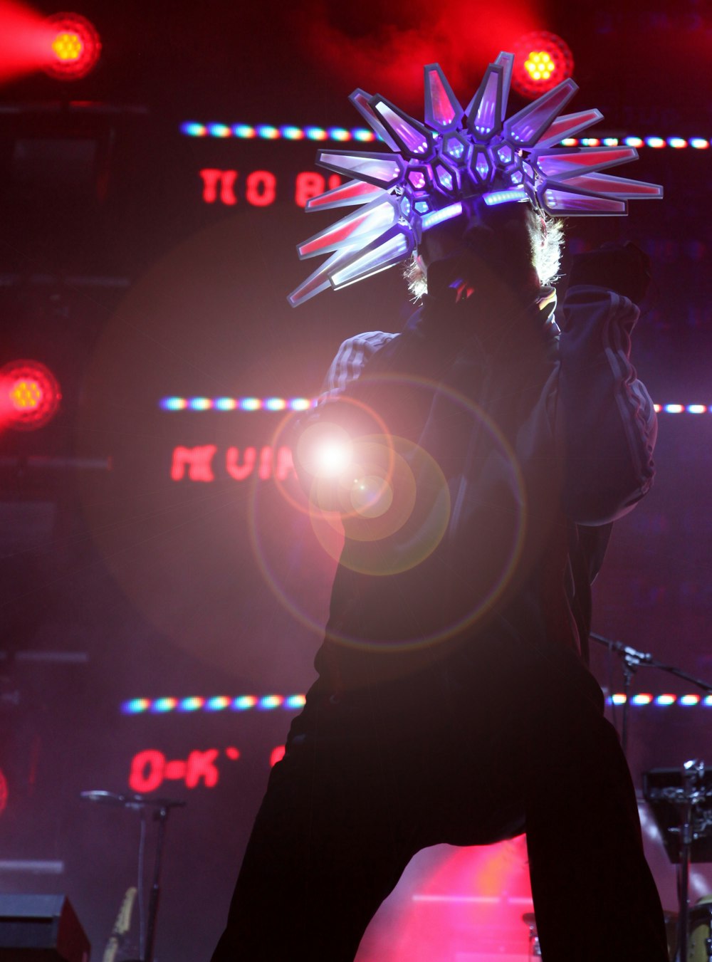 a man standing on top of a stage holding a microphone