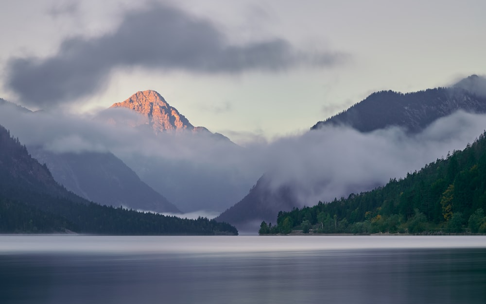 a mountain range with a body of water in the foreground