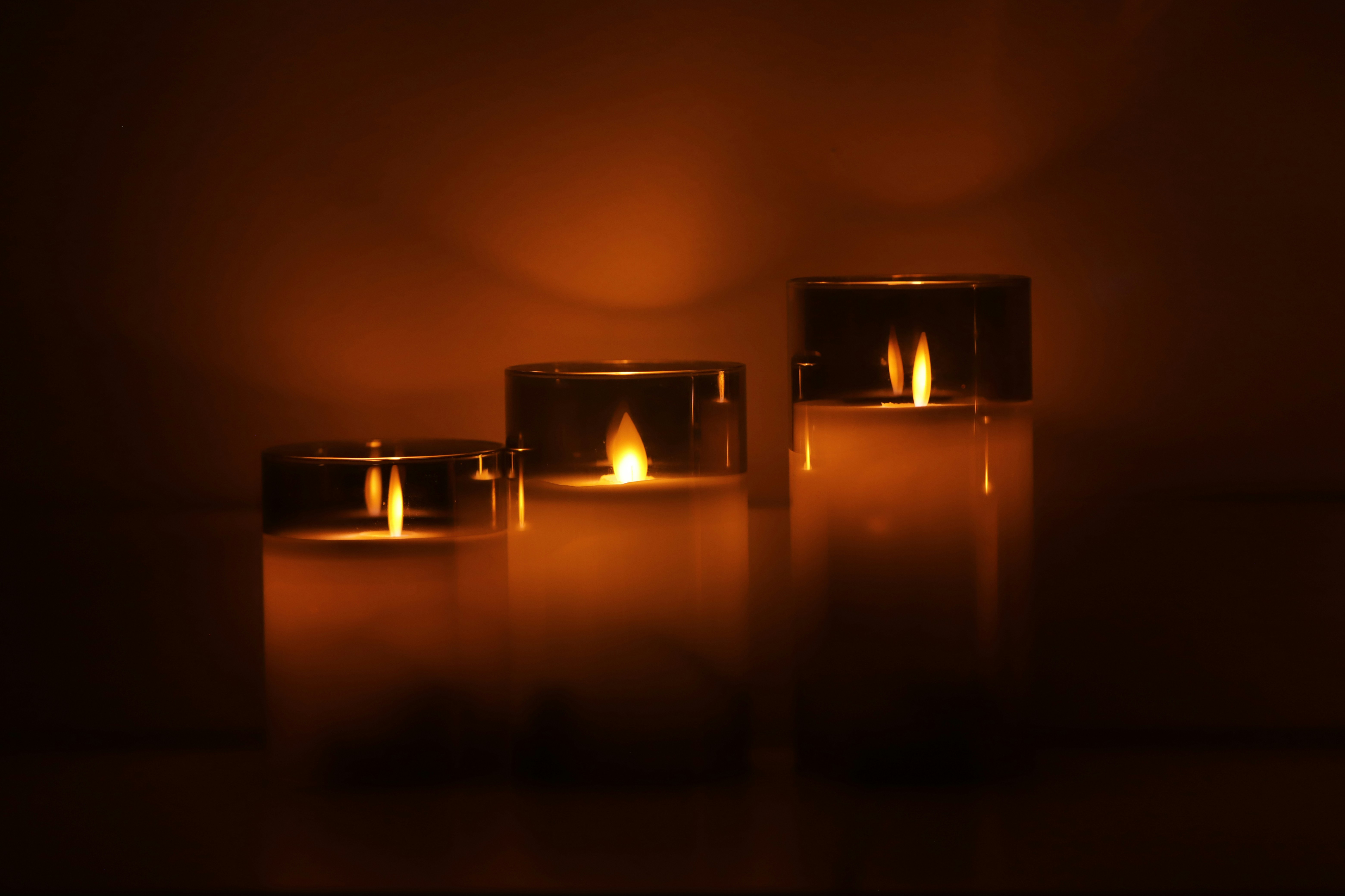 a group of three lit candles sitting next to each other
