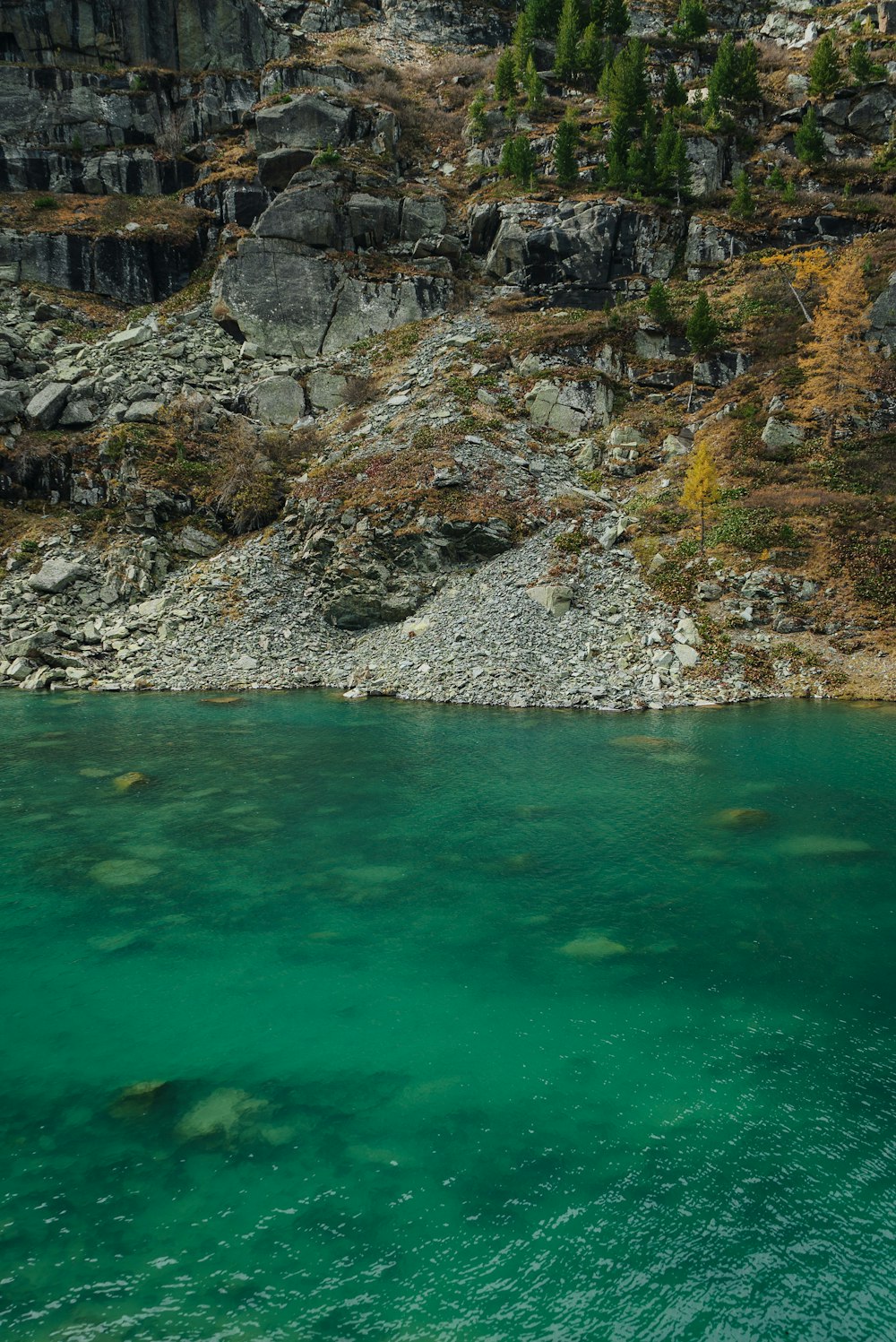 a body of water surrounded by a rocky cliff