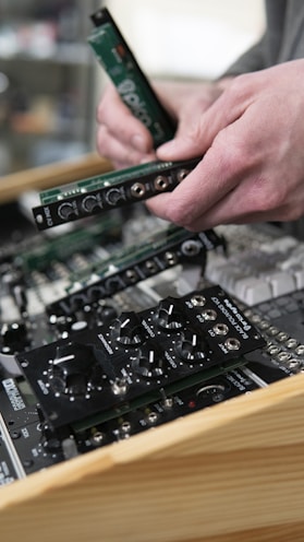 a person holding a piece of electronic equipment in their hands