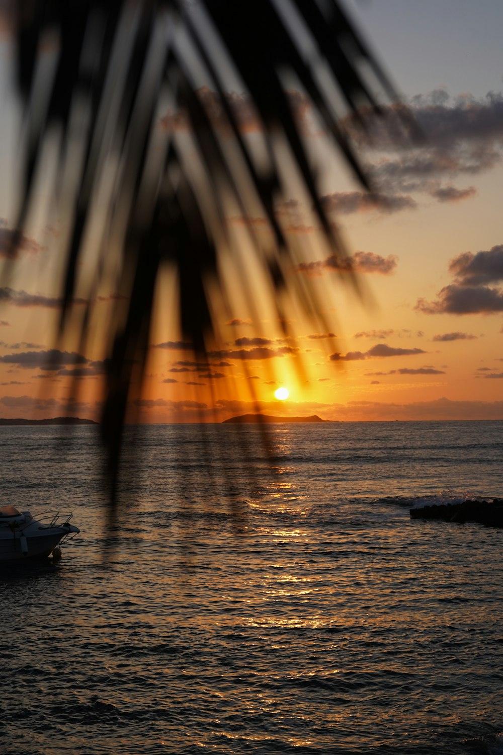 a boat is in the water at sunset