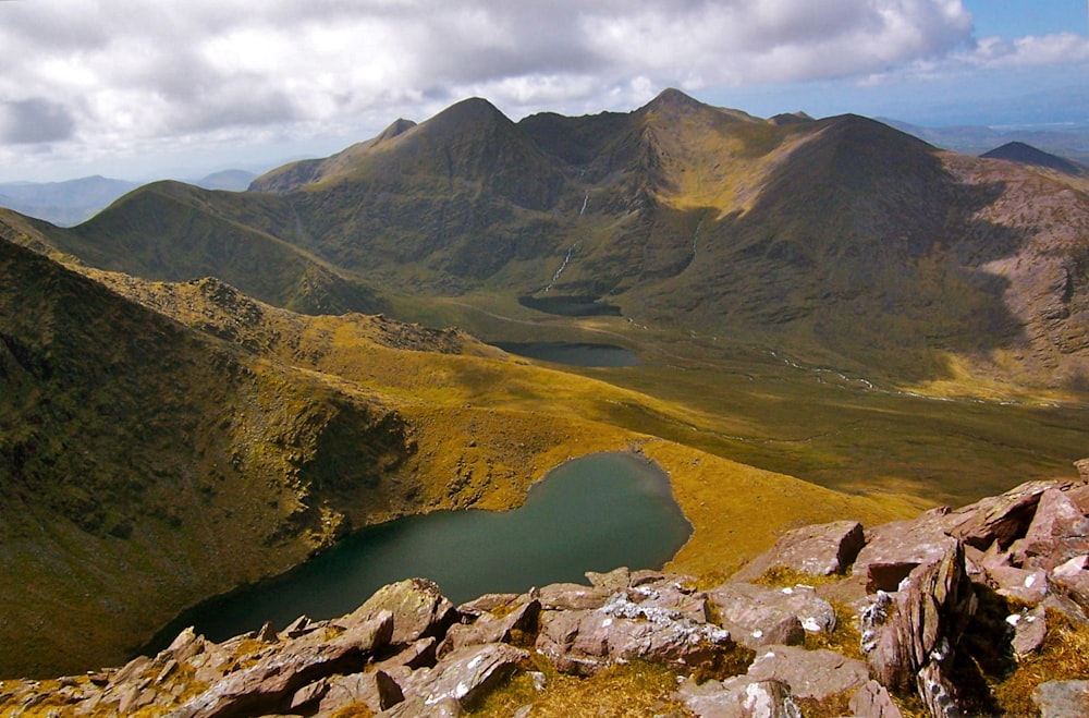 a view of a mountain range with a lake in the foreground