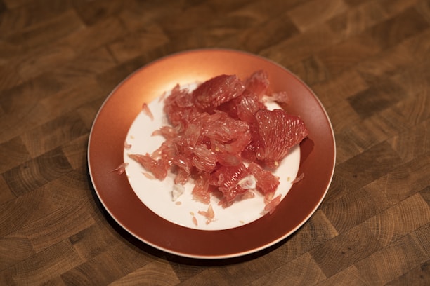 a plate of raw meat on a wooden table