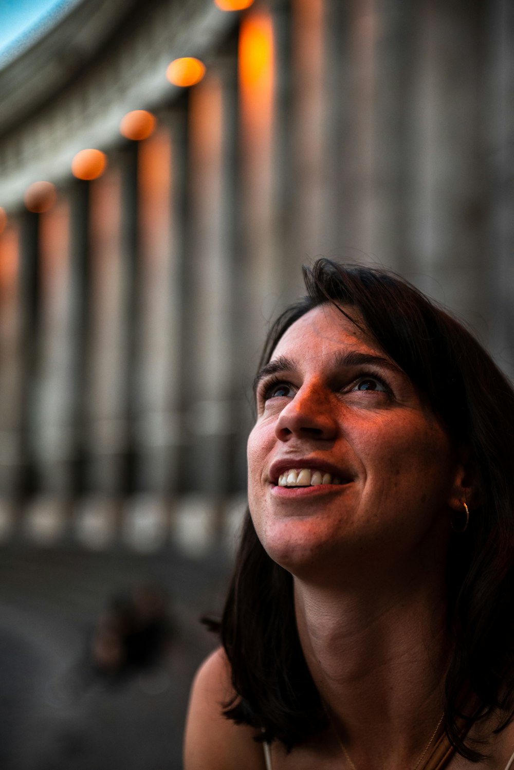 a woman is smiling and looking up at the sky