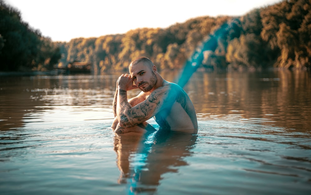 a man sitting in a body of water