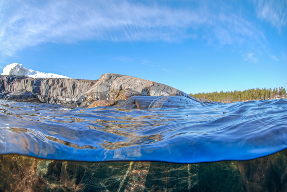 an underwater view of a mountain and a body of water